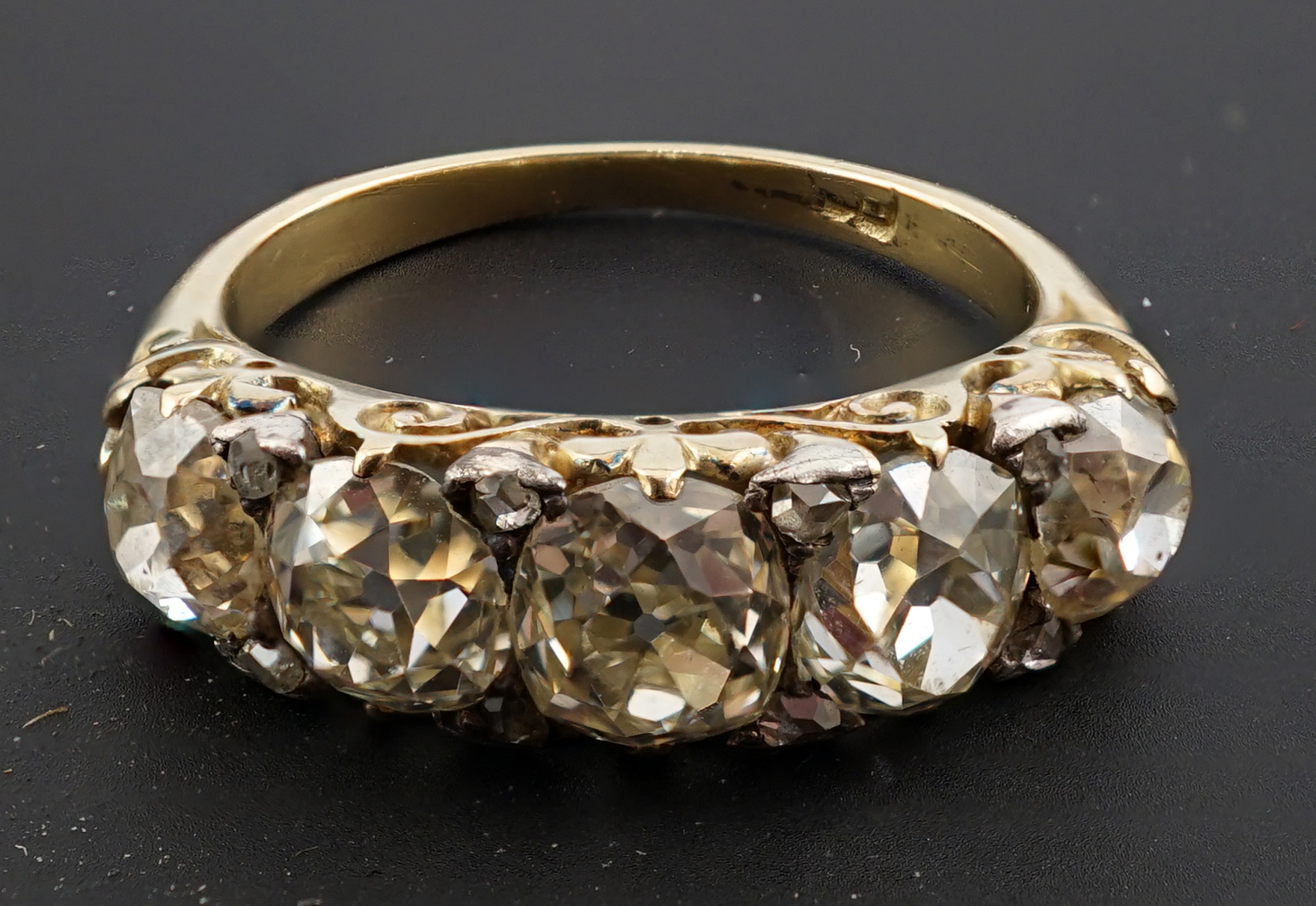 A Victorian 18ct and graduated five stone old round cut diamond set half hoop ring
